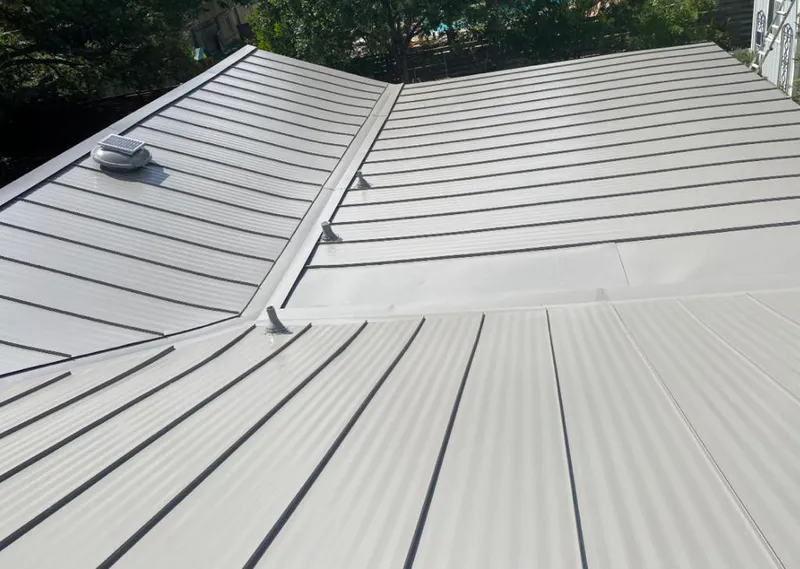 Solar attic fan installed on a metal roof for Roof Ventilation in Maple Shade